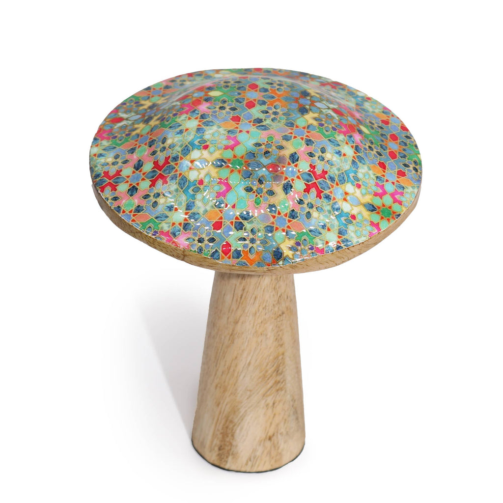 Small round wooden mushroom with a multicolored mosaic top and wooden base on a white background