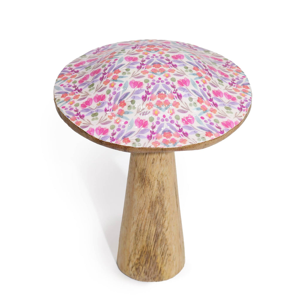 Small round table with a floral patterned top and wooden base on a white background