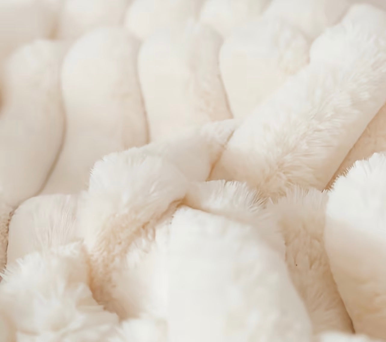 Close-up of a textured beige fabric cushion surface 