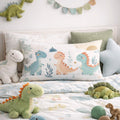 Children's bedroom with dinosaur-themed pillows and plush toys on a bed.
