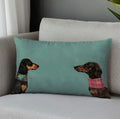 Decorative pillow with dachshund illustrations on a gray couch