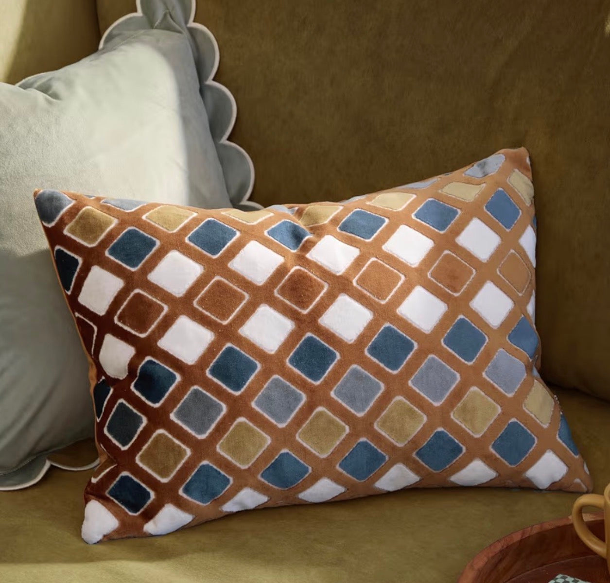geometric diamond ginger cushion cover on sofa