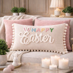 Decorative pillow with 'Happy Easter' text on a couch with candles and plants in the background.