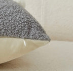Gray textured pillow on a beige sofa