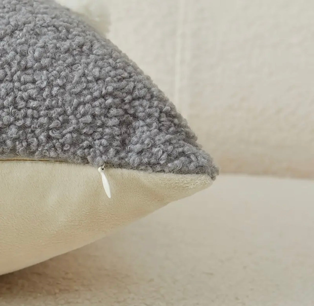 Gray textured pillow on a beige sofa