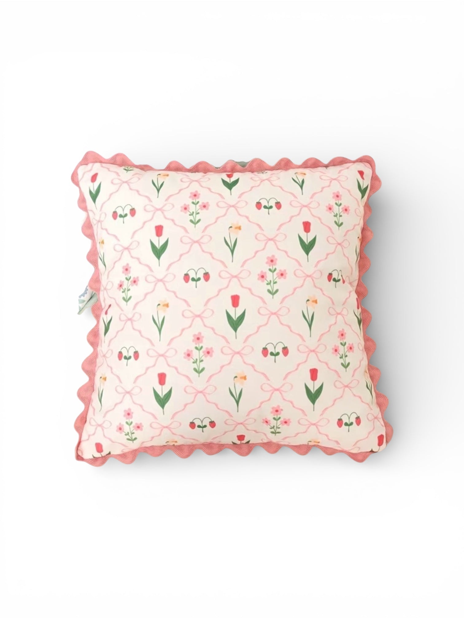 Decorative pillow with floral pattern and pink trim on a white background