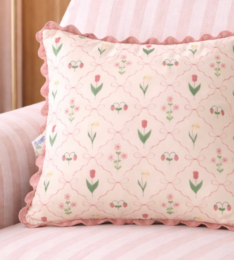 Decorative pillow with floral pattern on a light pink background