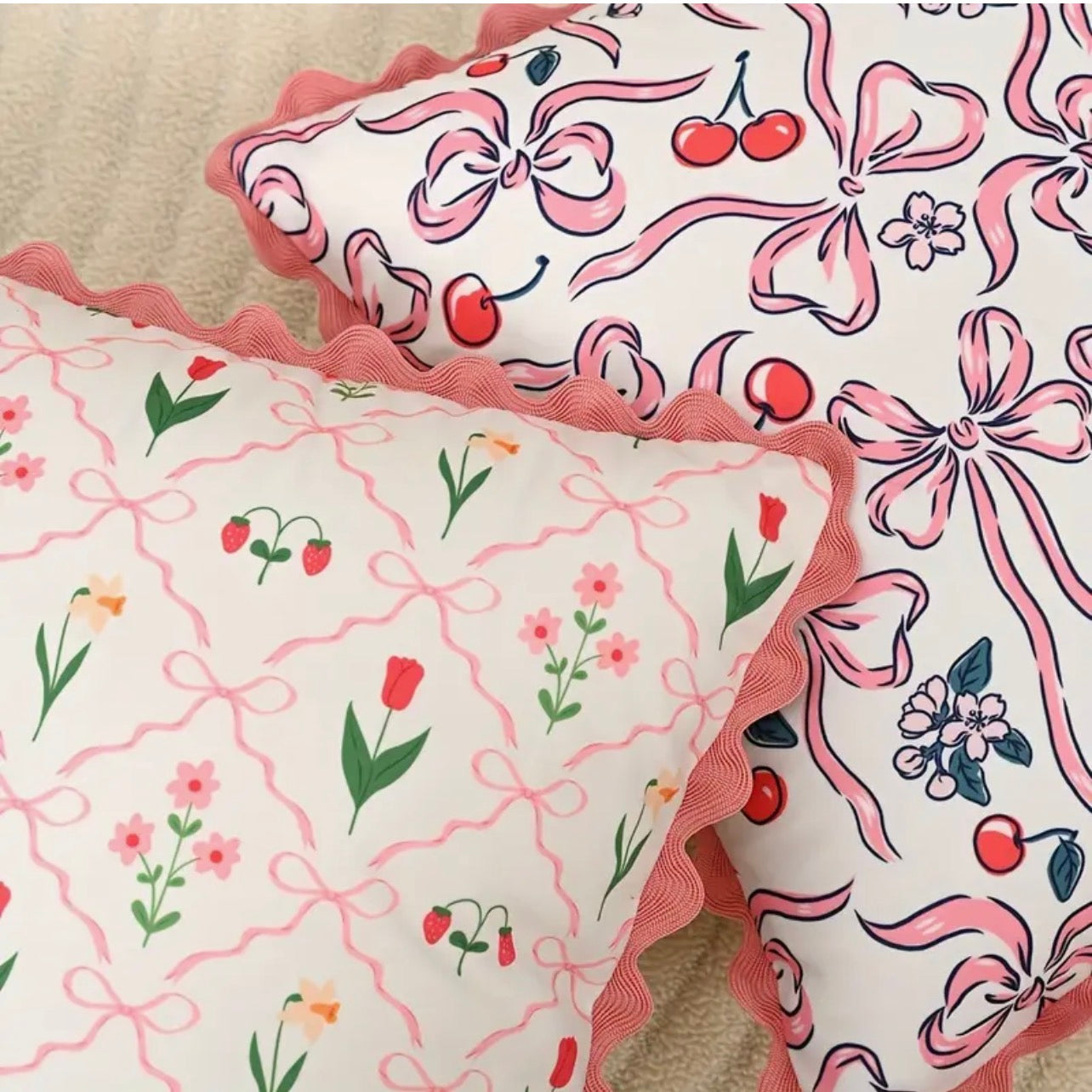 Two decorative pillows with floral and bow pattern on a beige surface