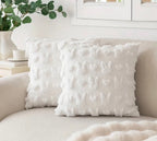 Textured white pillow on a beige sofa with a neutral background