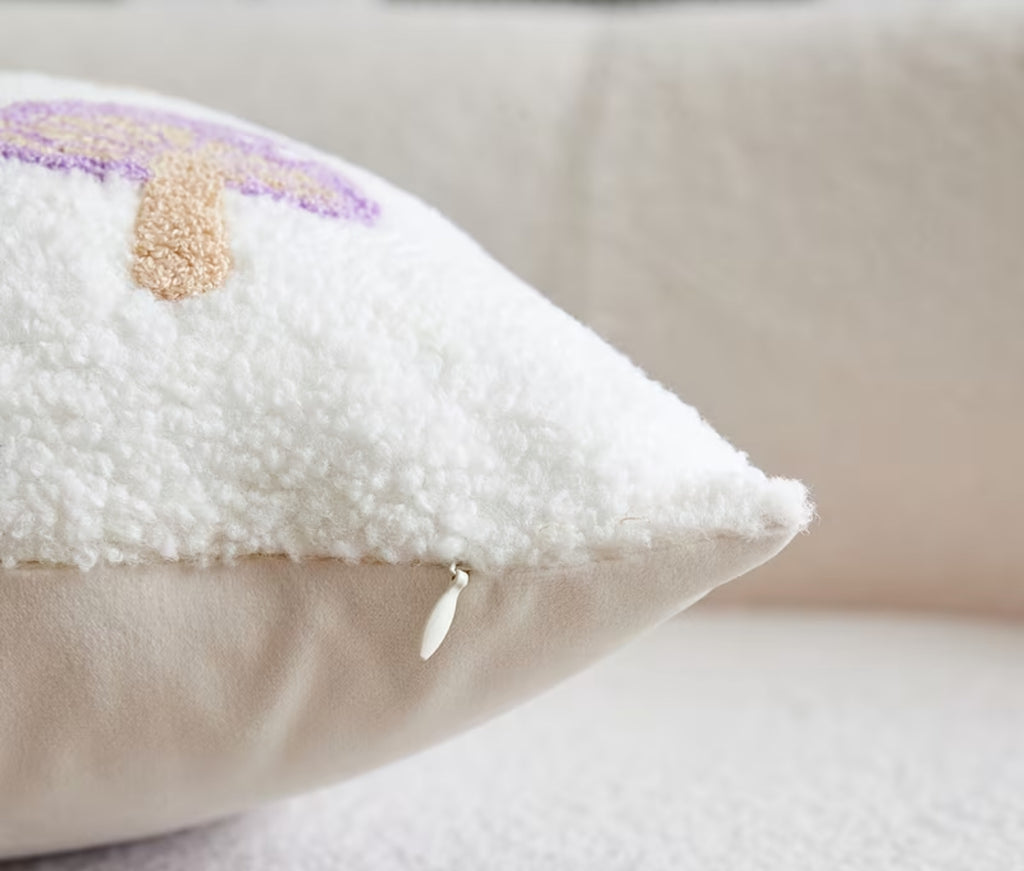 Close-up of a textured pillow with decorative elements on a neutral background