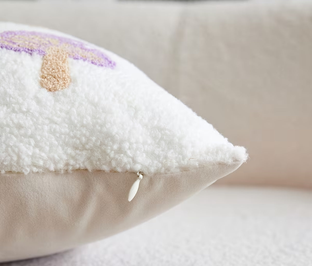 Close-up of a textured pillow with decorative elements on a neutral background