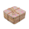 Set of square coasters with floral pattern tied with twine on a white background