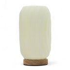 White textured table lamp with wooden base on a white background