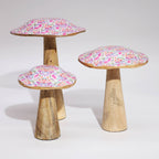 Three wooden stools with floral-patterned tops on a white background