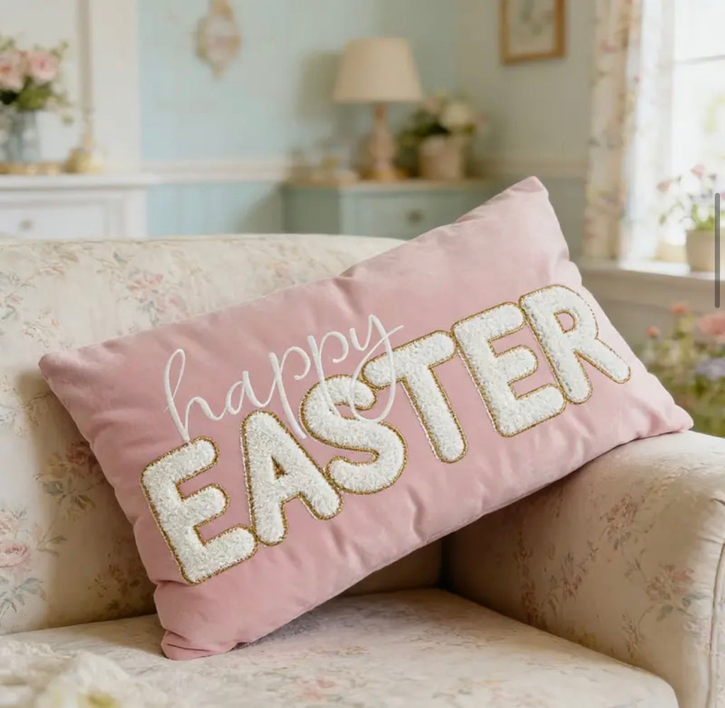 Pink pillow with 'happy EASTER' text on a floral sofa