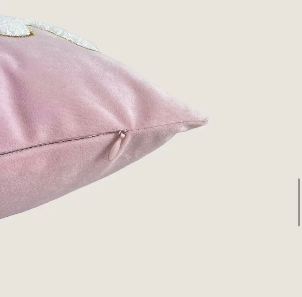 Pink pillow with decorative trim on a light background