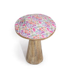 Small wooden stool with a colorful floral cushion on a white background