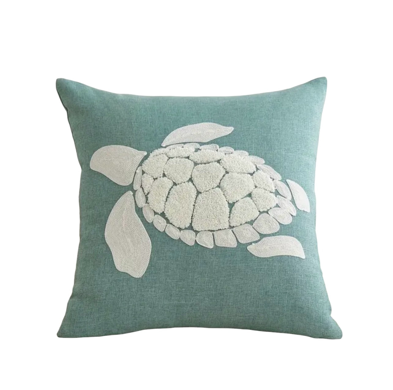 Teal pillow with a white turtle design on a white background
